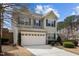 Two-story home featuring a two-car garage and neutral-colored exterior with well-maintained landscaping at 241 Westgrove Ct, Durham, NC 27703