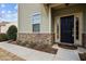 Inviting front entrance with a stylish black door and stone accents for curb appeal at 241 Westgrove Ct, Durham, NC 27703