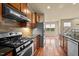 Updated kitchen with stainless appliances, wood floors, and open to dining area at 241 Westgrove Ct, Durham, NC 27703