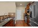 Well-equipped kitchen with stainless steel appliances, tile backsplash, and wooden cabinets at 241 Westgrove Ct, Durham, NC 27703