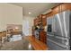 Modern kitchen features stainless steel appliances, stone counters and rich wooden cabinets at 241 Westgrove Ct, Durham, NC 27703