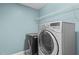 Laundry room featuring a large washer, dryer, and white wire shelving at 241 Westgrove Ct, Durham, NC 27703