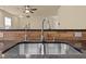 Close-up of a stainless steel sink and stone countertop with tile backsplash at 241 Westgrove Ct, Durham, NC 27703