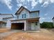 New two-story home with unfinished siding and an attached two-car garage at 243 Meadowbark Bnd # 28, Garner, NC 27529