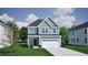 Charming two-story home with a front-facing two car garage, black front door and nicely manicured lawn at 243 Meadowbark Bnd # 28, Garner, NC 27529