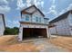 New two-story home with unfinished siding and an attached two-car garage at 243 Meadowbark Bnd # 28, Garner, NC 27529