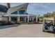 The clubhouse features a pergola, golf carts, and well-manicured landscaping creating a welcoming atmosphere at 249 High Ridge Ln, Pittsboro, NC 27312