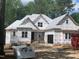 New construction home with building wrap and lumber on the lot at 249 High Ridge Ln, Pittsboro, NC 27312