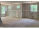 Unfinished room shows a spacious interior with drywall and bright, natural light streaming through the windows at 249 High Ridge Ln, Pittsboro, NC 27312