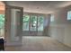 Bright unfinished room shows a view to a covered porch and lots of natural light through the large windows at 249 High Ridge Ln, Pittsboro, NC 27312