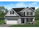 Charming two-story home featuring a two-car garage and welcoming front porch at 274 Yardley Dr, Smithfield, NC 27577