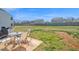 This backyard includes a patio with a table and chairs, perfect for enjoying the outdoors at 2741 Rains Dr, Haw River, NC 27258