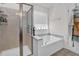 Bright bathroom featuring a tub, separate shower, and tile flooring at 2741 Rains Dr, Haw River, NC 27258