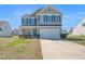 Charming two-story home with well-maintained lawn and inviting curb appeal on a sunny day at 2741 Rains Dr, Haw River, NC 27258