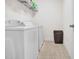 Laundry area with a washer, dryer, and storage shelves at 2741 Rains Dr, Haw River, NC 27258