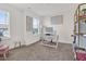 Well-lit home office with a large window, modern desk, and shelving unit at 2741 Rains Dr, Haw River, NC 27258
