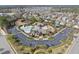Aerial view of community pool, clubhouse, tennis courts, and surrounding neighborhood at 2821 Casona Way, Raleigh, NC 27616