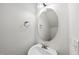 Clean bathroom with a round mirror and bronze fixtures at 2821 Casona Way, Raleigh, NC 27616