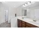 Bathroom with double sink vanity with dark wood cabinets and tile flooring at 2821 Casona Way, Raleigh, NC 27616