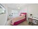Charming bedroom with a pink tufted bed frame, chandelier, and decorative accents at 2821 Casona Way, Raleigh, NC 27616