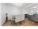 Dining area with a wooden table, upholstered chairs, and wood flooring, perfect for Gathering meals at 2821 Casona Way, Raleigh, NC 27616