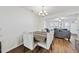 Well-lit dining room featuring a modern chandelier, wood floors, and neutral-toned seating at 2821 Casona Way, Raleigh, NC 27616