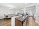 Open concept kitchen with granite countertops and view into the dining and living areas at 2821 Casona Way, Raleigh, NC 27616