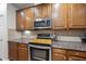 Close up of kitchen with granite countertops and stainless steel appliances at 2821 Casona Way, Raleigh, NC 27616