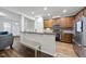 Modern kitchen with dark wood cabinets, breakfast bar, and stainless steel appliances at 2821 Casona Way, Raleigh, NC 27616