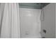 Tiled tub and shower stall featuring a chrome shower head and decorative curtain at 3080 Colony Rd # A, Durham, NC 27705