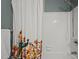 Bathroom with white tiled tub/shower, white decorative curtain and chrome shower head at 3080 Colony Rd # A, Durham, NC 27705