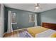 Bedroom with two windows, wood-look floors and a decorative rug at 3080 Colony Rd # A, Durham, NC 27705