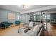 Open-concept living room with modern decor, gray sofas, and a seamless flow at 3080 Colony Rd # A, Durham, NC 27705