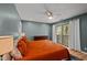 Bright bedroom with a sliding glass door to the balcony and a ceiling fan at 3080 Colony Rd # A, Durham, NC 27705