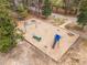 Community playground featuring slides, picnic tables, and play equipment surrounded by wooded areas at 3080 Colony Rd # A, Durham, NC 27705