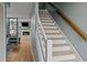View of staircase and open-concept living area with fireplace beyond at 3080 Colony Rd # A, Durham, NC 27705