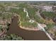 Aerial view of a picturesque neighborhood nestled among lush greenery and a serene pond at 3103 Woodland Park Rd, Durham, NC 27703