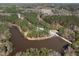 A captivating aerial view of a wooded community surrounding a scenic lake at 3103 Woodland Park Rd, Durham, NC 27703