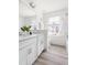 Bright bathroom features a double vanity, modern fixtures, and wood-look tile flooring at 3103 Woodland Park Rd, Durham, NC 27703