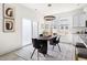 Dining area featuring a stylish table, modern lighting, and sliding glass door for seamless indoor-outdoor living at 3103 Woodland Park Rd, Durham, NC 27703