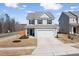 Charming two-story home with a two-car garage, well-maintained lawn, and cozy front porch at 3103 Woodland Park Rd, Durham, NC 27703