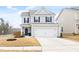 Charming two-story home with light gray siding, black shutters, and a two-car garage at 3103 Woodland Park Rd, Durham, NC 27703