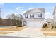 Charming home with light gray siding, black shutters, two-car garage and long driveway at 3103 Woodland Park Rd, Durham, NC 27703