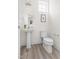Cozy half bathroom featuring a pedestal sink, toilet, and neutral decor at 3103 Woodland Park Rd, Durham, NC 27703