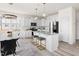Bright kitchen features stainless appliances, granite counters, island seating and a view of the dining area at 3103 Woodland Park Rd, Durham, NC 27703