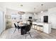 Eat-in kitchen with stainless steel appliances, granite counters, island seating, and modern pendant lighting at 3103 Woodland Park Rd, Durham, NC 27703