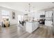Open kitchen features stainless appliances, island with bar seating, and an adjacent dining area with natural light at 3103 Woodland Park Rd, Durham, NC 27703