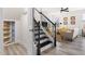 Stairway leading to an open-concept living room with modern decor and plenty of natural light at 3103 Woodland Park Rd, Durham, NC 27703