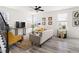 Bright living room with wood floors, neutral sofa, yellow chairs, and ample light at 3103 Woodland Park Rd, Durham, NC 27703