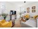 Cozy living room featuring a neutral sofa, yellow armchairs, and jute rug at 3103 Woodland Park Rd, Durham, NC 27703